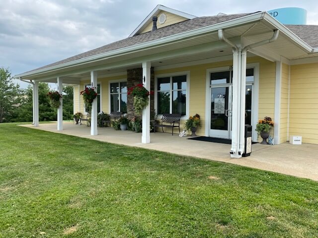 front exterior view of veterinary facility - painted yellow with colonial style porch