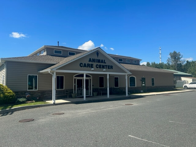 front exterior view of veterinary facility - painted gray with colonial style porch